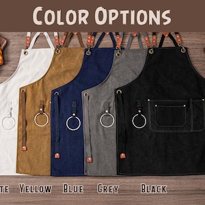 May include: Aprons in white, yellow, blue, grey, and black, with leather straps and metal ring details. The aprons are displayed with the text "COLOR OPTIONS" and the color names "WHITE", "YELLOW", "BLUE", "GREY", and "BLACK".