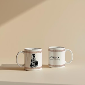 May include: Two white ceramic mugs with a brown geometric border. One mug features a black illustration of Athena, the Greek goddess, and the other mug has the text "ATHENA Wisdom & Strategy."