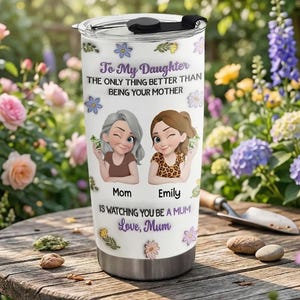 May include: A white stainless steel tumbler with a black lid. The tumbler features a cartoon illustration of a mother and daughter, with text that reads "To My Daughter" and "Love, Mum". Floral accents decorate the tumbler.