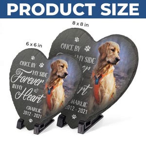 May include: Heart-shaped slate pet memorial stones with a photo of a golden retriever. The stones are 6 x 6 inches and 8 x 8 inches. Text includes "Once by my side, forever in my heart" and the pet's name and dates.