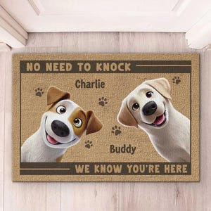 May include: A rectangular doormat with the text "NO NEED TO KNOCK - WE KNOW YOU'RE HERE". The mat features cartoon images of two dogs, a Jack Russell Terrier and a Labrador Retriever, with the names "Charlie" and "Buddy" above and below the dogs.