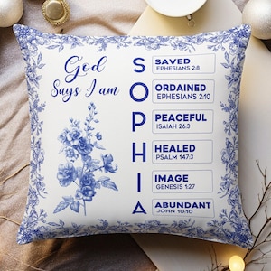 May include: Square white pillow with a blue floral design border and a central floral bouquet. The pillow features the text "God Says I am SOPHIA" with associated biblical verses. The design is in shades of blue.