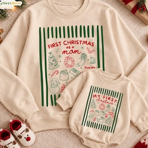 May include: A beige adult sweatshirt and a matching infant bodysuit featuring green vertical stripes and red text. The adult shirt reads First Christmas as a mom, while the infant bodysuit reads My First Christmas with holiday icons.