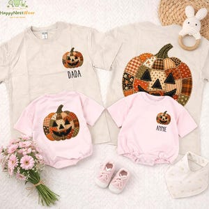May include: Two beige t-shirts and two light pink baby bodysuits featuring patchwork-style pumpkin graphics. One t-shirt has the text DADA, and one bodysuit has the text ANNIE. The set includes a pair of pink baby shoes and a white bib.