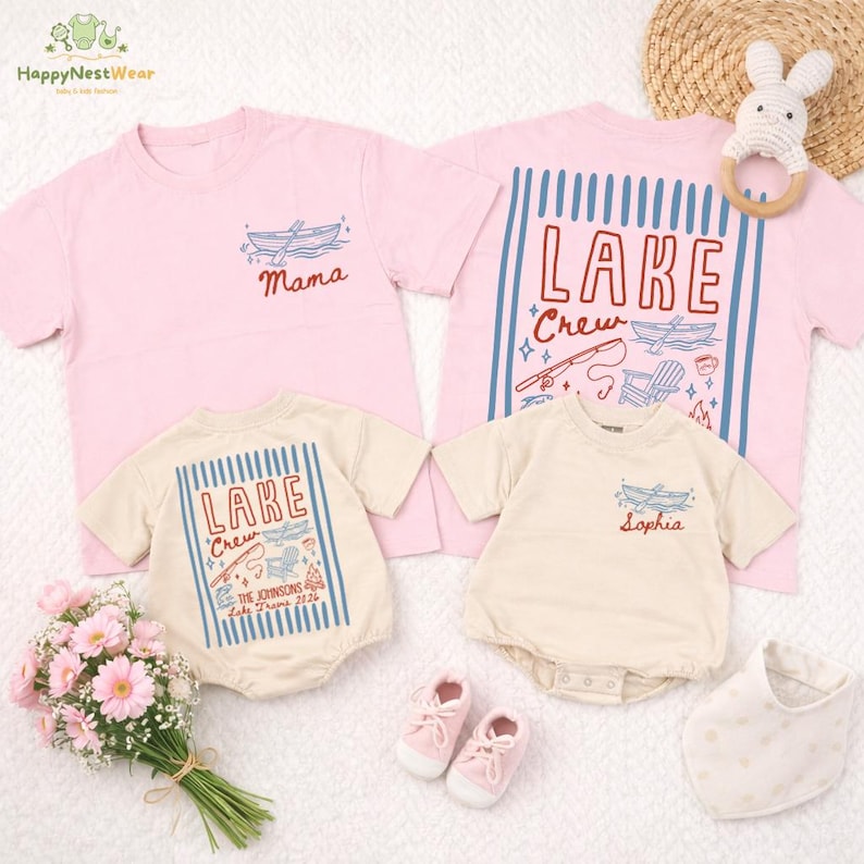 May include: Pink and beige family matching t-shirts and rompers with lake-themed designs. The shirts and rompers feature boat and lake graphics, with text that reads "Mama", "Lake Crew", and a personalized name. Accessories include baby shoes, a bib, and a bunny rattle.