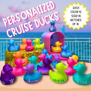 May include: A collection of small, colorful rubber ducks in various shades of purple, pink, orange, yellow, green, and blue. Some ducks feature the text "STAR", "ALLURE", or "10-4-26". A pink and blue mailbox sits among the ducks.