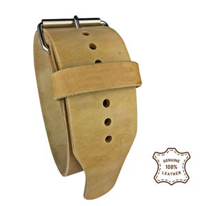 Peut inclure: Bracelet de montre en cuir marron clair avec boucle argent&eacute;e. Le bracelet comporte plusieurs trous de r&eacute;glage et une petite boucle pour fixer l'exc&eacute;dent de longueur. L'image comprend un badge indiquant "CUIR V&Eacute;RITABLE 100 %".