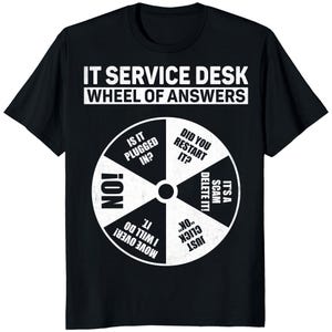 May include: Black t-shirt with the text "IT SERVICE DESK WHEEL OF ANSWERS" above a white wheel graphic. The wheel has segments with common IT support phrases like "Did you restart it?" and "Is it plugged in?"
