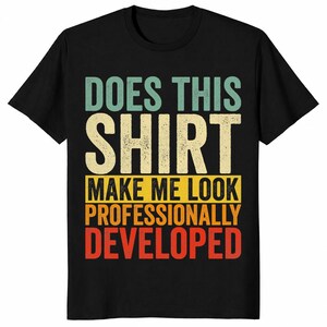 May include: A black short-sleeved t-shirt featuring a multi-colored graphic with the text "DOES THIS SHIRT MAKE ME LOOK PROFESSIONALLY DEVELOPED" in a distressed, retro-inspired font style with light blue, cream, yellow, orange, and red colors.