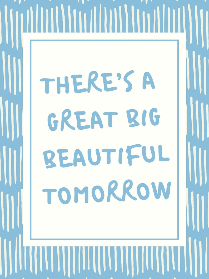 May include: A rectangular card with a white border and a light blue background featuring vertical white lines. The text "THERE'S A GREAT BIG BEAUTIFUL TOMORROW" is written in light blue within the white border.