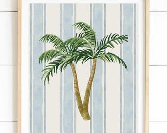 Könnte beinhalten: Aquarelldruck von zwei Palmen mit grünen Wedeln und braunen Stämmen. Der Hintergrund zeigt vertikale Streifen in Hellblau und Off-White, gerahmt in einem hellen Holzrahmen.