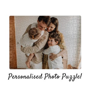 May include: A personalized photo puzzle featuring a family of five. The puzzle shows a family embracing each other. The text "Personalised Photo Puzzle!" is written in a cursive font at the bottom of the image.