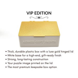 May include: A white plastic keepsake box with a gold hinged lid. The text "VIP EDITION" is at the top, and "AUSSIE GIFT PRINTS" is on the front. The box is designed for puzzles and has a durable construction.
