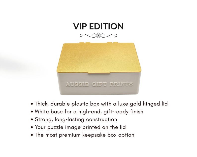 May include: A white plastic keepsake box with a gold hinged lid. The text "VIP EDITION" is at the top, and "AUSSIE GIFT PRINTS" is on the front. The box is designed for puzzles and has a durable construction.