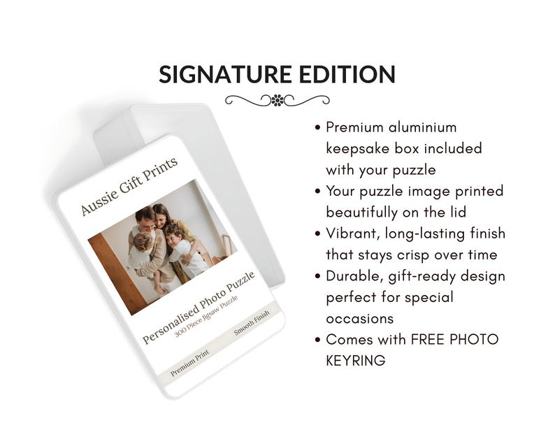 A white metal keepsake box with a personalized photo puzzle lid. The lid features a family photo and the text "Aussie Gift Prints" and "Personalised Photo Puzzle". The words "SIGNATURE EDITION" are at the top.