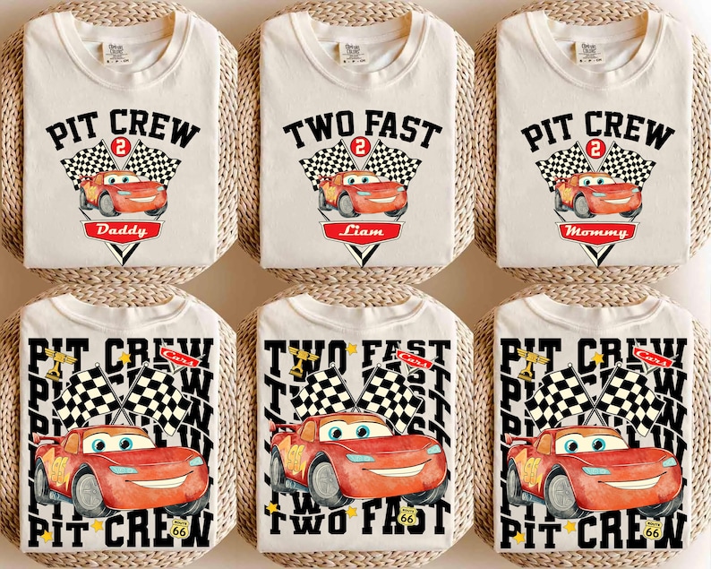 May include: Off-white t-shirts with race car graphics. Some shirts say "Pit Crew" with "Daddy" or "Mommy" below. Others say "Two Fast" with "Liam" below. Checkered flags and the number 2 are also featured.