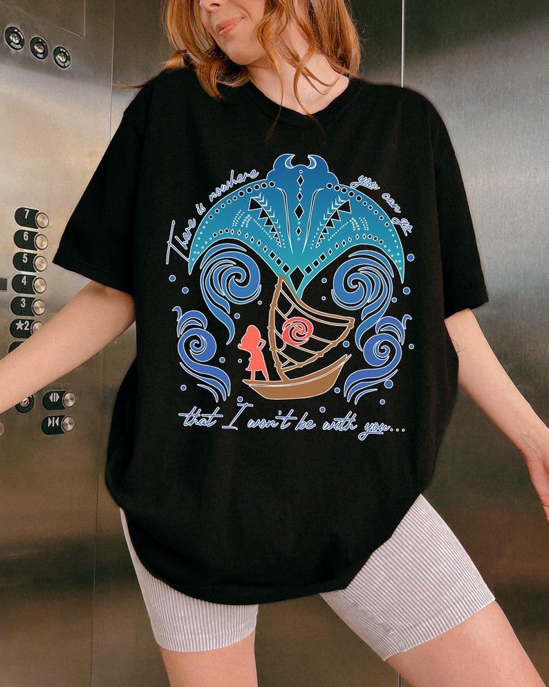 May include: Black t-shirt featuring a colorful graphic design with the text "There is nowhere that I won't be with you...". The design includes a boat, a figure, and stylized waves and palm tree elements in blue and brown.