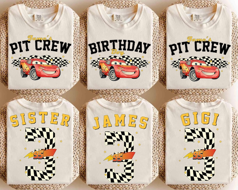 May include: Off-white t-shirts with various designs. Some shirts say "James' Pit Crew" with a red race car graphic. Others say "Birthday Boy", "Sister", "James", and "Gigi" with a number 3 and the number 95.