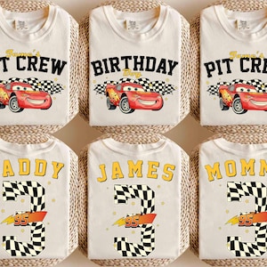 May include: A white ceramic mug with a black handle and the text "But First, Coffee" in a black, handwritten-style font. The mug is on a white surface.