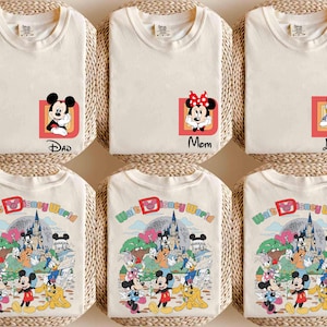 May include: Off-white t-shirts featuring Disney characters. One shirt has Mickey Mouse with "Dad" text, another has Minnie Mouse with "Mom", and a third has Daisy Duck with "Lisa". The other shirts display a colorful "Walt Disney World" graphic.