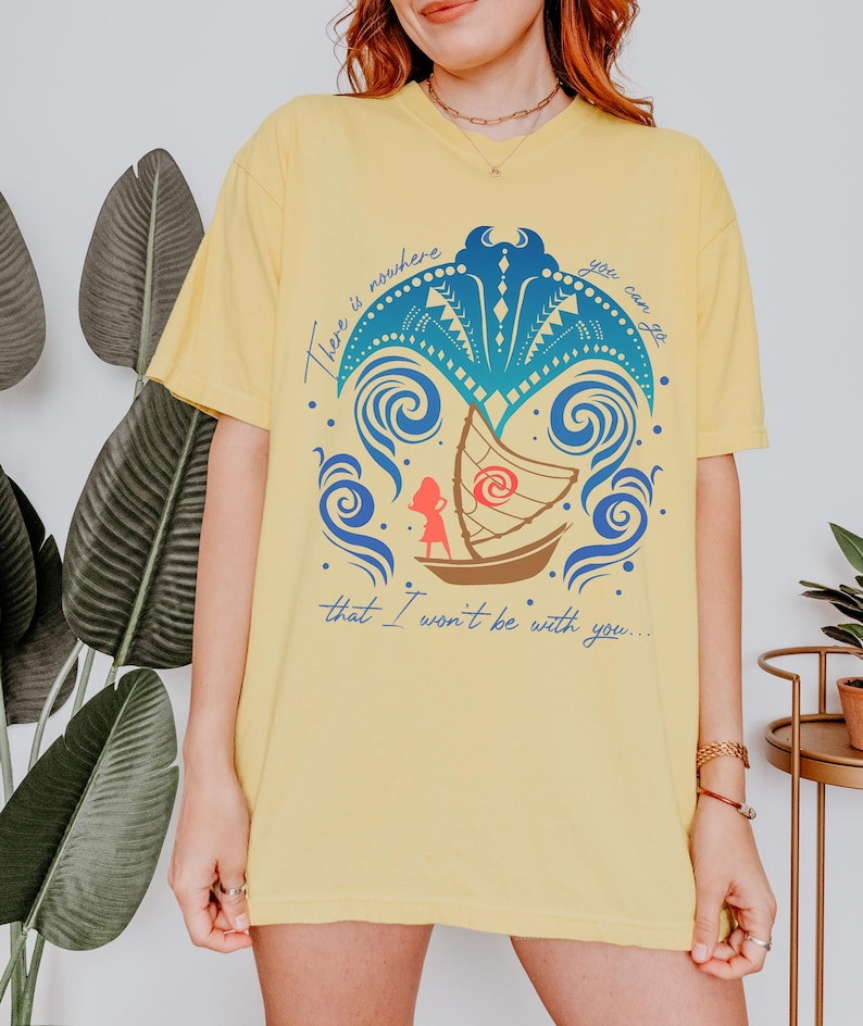 May include: Yellow t-shirt with a graphic design featuring a boat, a figure, and ocean waves. The text on the shirt reads "There is nowhere you can go that I won't be with you..."
