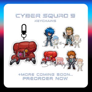 May include: A collection of Cyber Squad 9 keychains featuring chibi-style characters and a red robotic vehicle. The display includes text reading CYBER SQUAD 9 KEYCHAINS and +MORE COMING SOON... PREORDER NOW. Each acrylic charm shows detailed artwork.