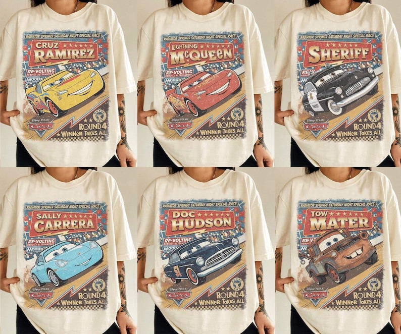 May include: A cream-colored t-shirt featuring a vintage-style graphic print of Disney Pixar Cars characters including Cruz Ramirez, Lightning McQueen, Sheriff, Sally Carrera, Doc Hudson, and Tow Mater with Radiator Springs race text.