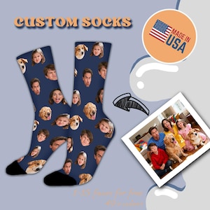 May include: Custom socks with a navy blue background, featuring a pattern of faces and dog faces. The socks have black toes and heels. The words "CUSTOM SOCKS" are in orange text at the top. A "Made in USA" sticker is in the upper right corner.