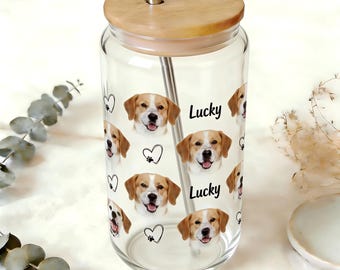 May include: A clear glass tumbler with a wooden lid and metal straw. The tumbler is decorated with images of a dog's face, hearts, paw prints, and the word "Lucky".