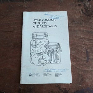 May include: A vintage pamphlet titled "Home Canning of Fruits and Vegetables" with a black and white illustration of two jars of preserved food. The pamphlet is from the Franklin County Extension Service, Court House, Greenfield, Mass. The pamphlet is available to the public without regard to race, color, or national origin. It is a Home and Garden Bulletin, Number 8, prepared by the Agricultural Research Service.