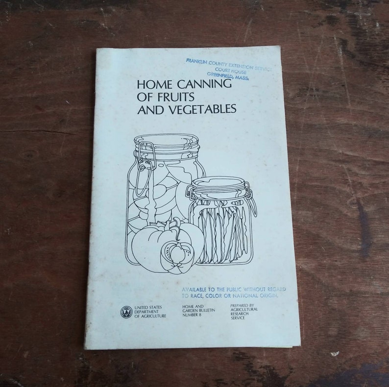 May include: A vintage pamphlet titled "Home Canning of Fruits and Vegetables" with a black and white illustration of two jars of preserved food. The pamphlet is from the Franklin County Extension Service, Court House, Greenfield, Mass. The pamphlet is available to the public without regard to race, color, or national origin. It is a Home and Garden Bulletin, Number 8, prepared by the Agricultural Research Service.