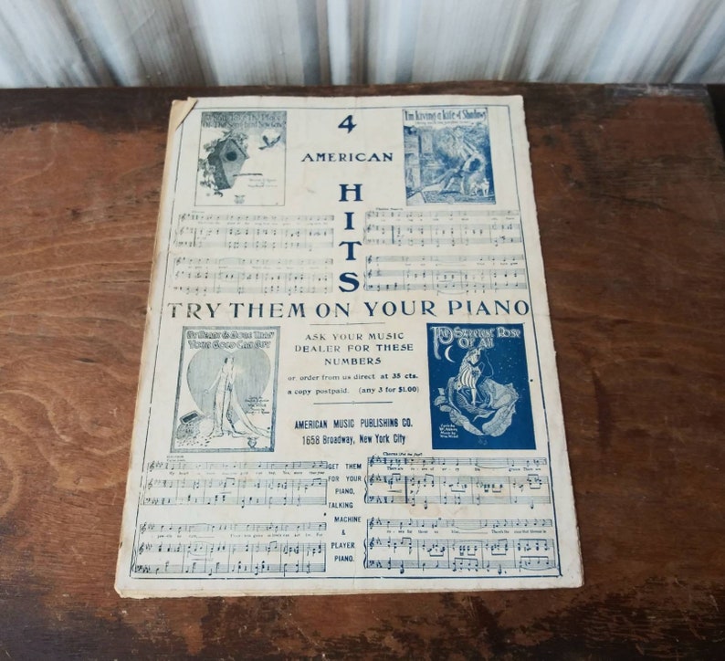 May include: A vintage sheet music cover with a blue and white design. The cover features the text "4 American Hits" and "Try Them On Your Piano". The cover also includes images of a birdhouse, a woman in a white dress, and a woman in a blue dress.