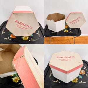 May include: Hexagonal vintage box with a white base and a pink rim. The box lid features the text "PARISEAU'S" in red, along with the address "1000 Elm Street, Manchester, N.H.". The box is open and closed in different views.