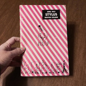 May include: A pink and white striped cover for a June 1953 issue of the Stylus, the Boston College magazine. The cover features a black and white illustration of a clown with a red nose and a red and white hat. The cover also features a black and white illustration of a group of people walking in a parade.
