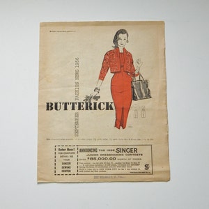 May include: A vintage advertisement for Butterick sewing patterns featuring a woman wearing a red dress and a patterned jacket. The ad also announces a 1956 Singer Junior Dressmaking Contest with over $85,000 in prizes.