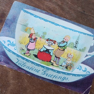 Postal antigua Valentine Saludos sin mie con matasellos 1906 Taza de té holandés niños perro picnic de madera zuecos Raphael Tuck Vintage Ephemera