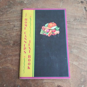 May include: The Home Canners Text Book with a yellow cover and a black background featuring a colorful illustration of various vegetables and fruits.