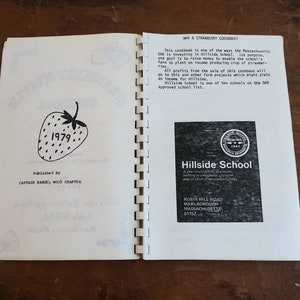 May include: Open cookbook titled "Strawberry Kisses Cookbook 1979" with a strawberry illustration. The book is published by Captain Samuel Wood Chapter. The right page has text about the cookbook's purpose and a Hillside School logo.