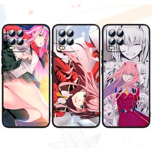 May include: Three phone cases featuring a pink-haired anime character with different designs. The first case features the character in a white and green outfit. The second case features the character in a red and white outfit. The third case features the character in a red and white outfit with a collage of different images.
