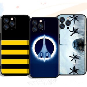 May include: Three phone cases with unique designs. One case is black with yellow horizontal stripes. Another features a Concorde jet against a blue background with a white ring. The third case has a space-themed design with a satellite and black star shapes.