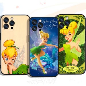May include: Three phone cases featuring Tinkerbell. The cases have different backgrounds: a light tan case with Tinkerbell winking, a blue case with Tinkerbell in a pose, and a green case with Tinkerbell and the text "Tinker Bell".