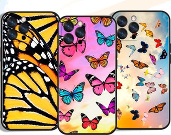 May include: Three phone cases with butterfly designs. One case features a close-up of a yellow and black butterfly wing. Another case has pink, blue, and orange butterflies on a pink and purple background. The third case has butterflies on a sky background.