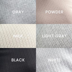 May include: A selection of six fabric samples in shades of grey, powder, milk, light grey, black, and white. Each fabric has a ribbed design with small, perforated holes. The colour names are printed in white text on each swatch.