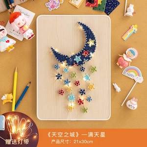 May include: A wooden wall hanging featuring a crescent moon and star design. The moon is dark blue with embedded lights and stars, with additional star-shaped lights cascading below. The wooden board measures approximately 8.3 x 11.8 inches.