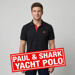 May include: Black polo shirt with a red collar trim and a small logo on the chest. The shirt has short sleeves and is being modeled. The text "PAUL & SHARK YACHT POLO" is displayed in a red rectangle.