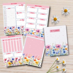 May include: A set of planner pages and a spiral-bound notebook featuring a floral design with pink, blue, and yellow wildflowers at the bottom. The pages include headers for Daily Planner, Weekly Planner, Undated Monthly, Notes, and My Planner.