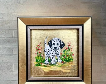 May include: Square framed painting of a Dalmatian puppy with black spots, standing in a field of green grass and red flowers. The frame is gold with a black inner border. The background is gold.