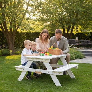 May include: A family of four sits at a white picnic table in a grassy backyard. They are playing with colorful wooden blocks and a wicker basket. The table has attached benches. The scene is set in a well-maintained garden with trees.