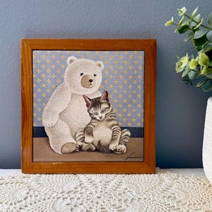 May include: A white ceramic mug with a black handle and the text "But First, Coffee" in a black, bold font. The mug is sitting on a wooden surface. The mug is approximately 4 inches tall.