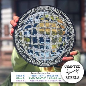 May include: Round iron-on patch featuring a detailed embroidered globe design, encased in silver chain links. The globe shows continents in shades of green and yellow against a blue ocean. The patch is available in three sizes, with the largest measuring 9.3 x 9.3 inches.